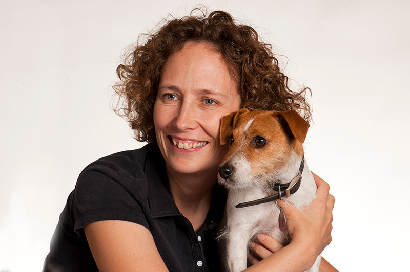 Professor Syme holding a small dog