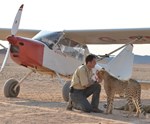 Alan with cheetahs and plane